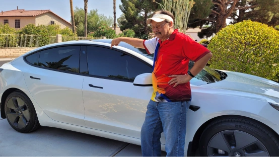 Customer of Unison standing in front of his vehicle