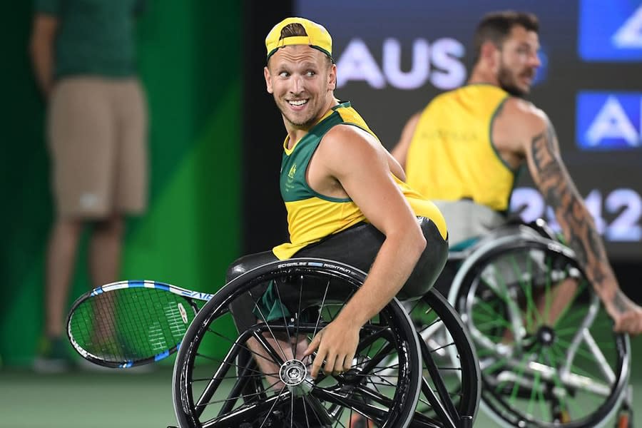 Dylan Alcott man sitting in wheelchair on tennis court