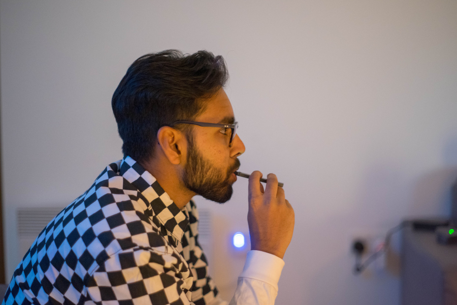 A young person vaping at home.