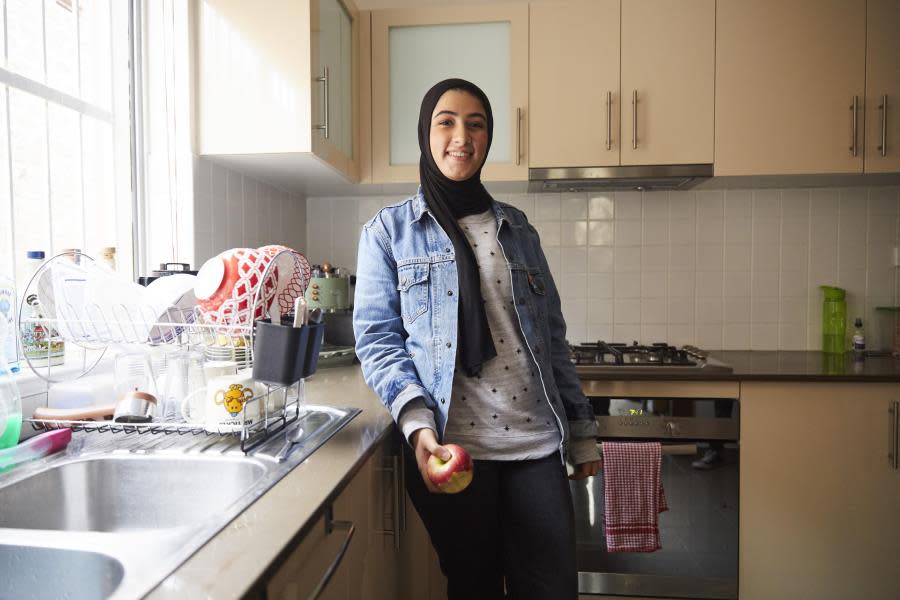 Girl in hijab standing in kitchen