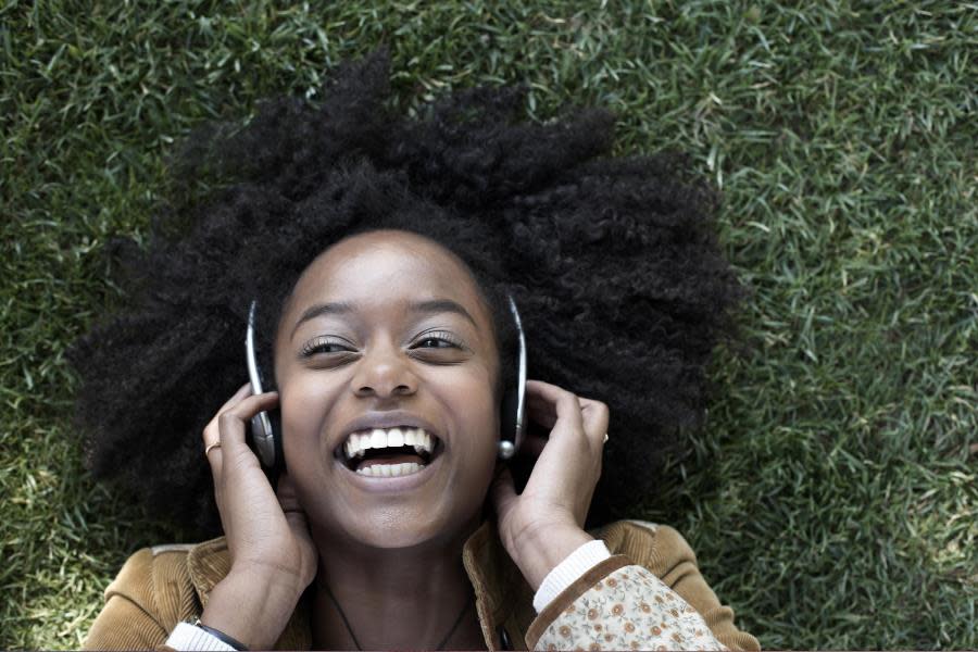 Girl listening to music on grass