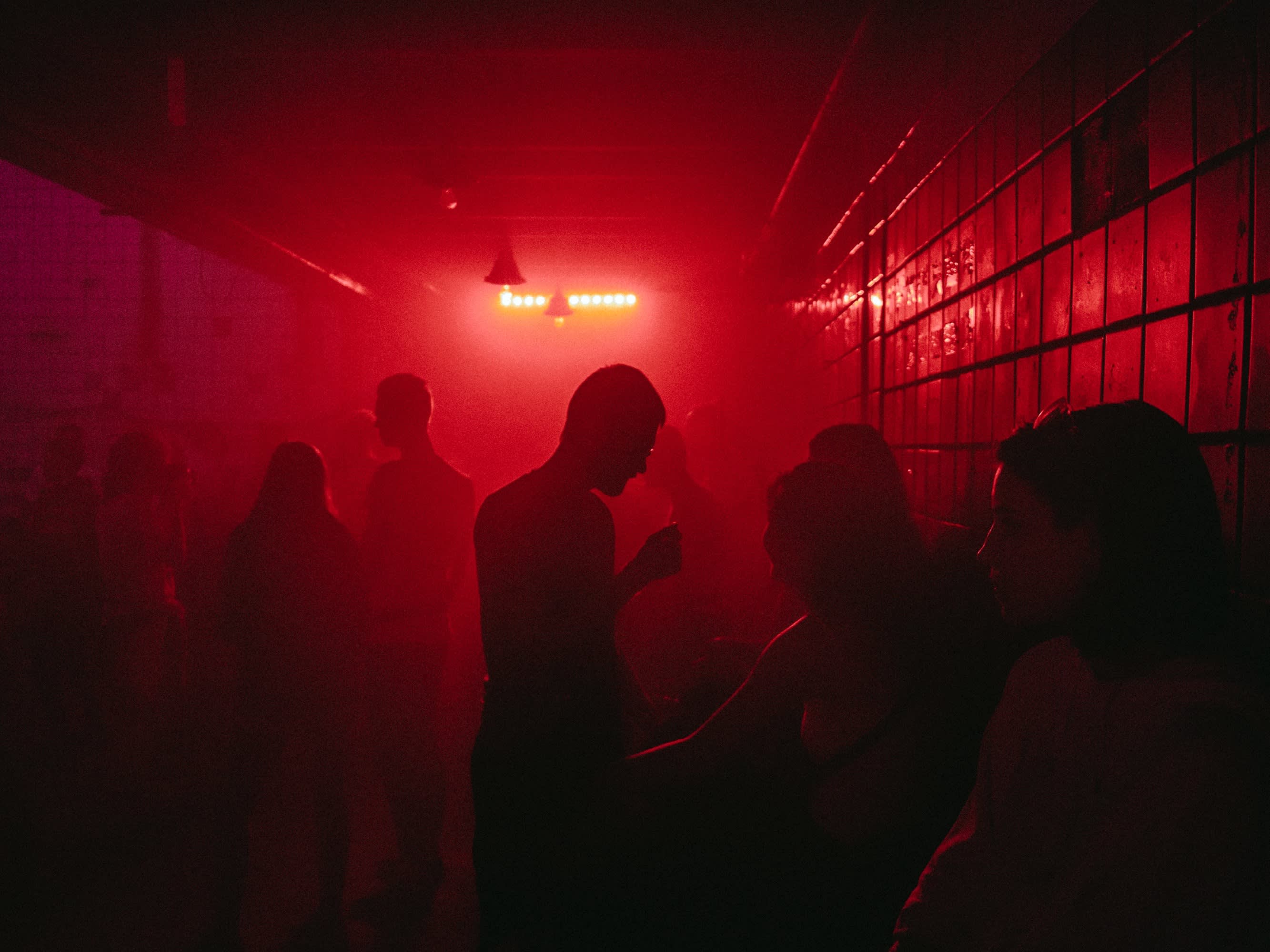 red dark space with people's silhouettes