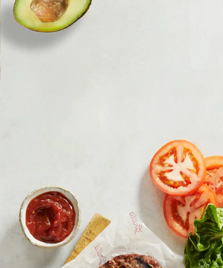 Grilled pineapple and sliced tomatoes on a grey background
