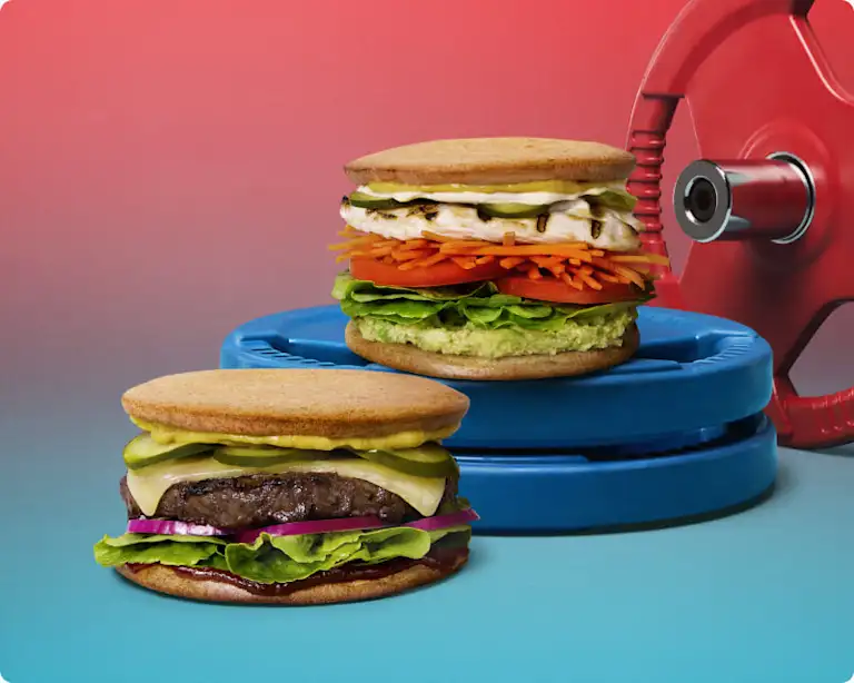 Low carb SuperBun beef and chicken burgers on weight plates