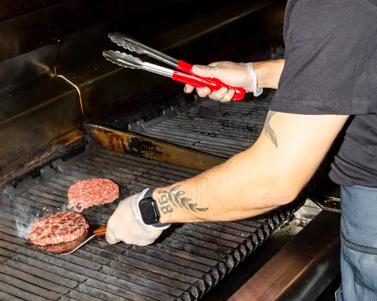 Flipping burgers on a grill