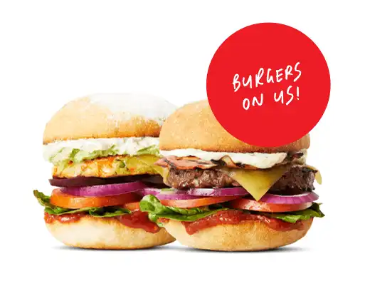 Two beef burgers side by side. A red sticker reads 'burgers on us!'