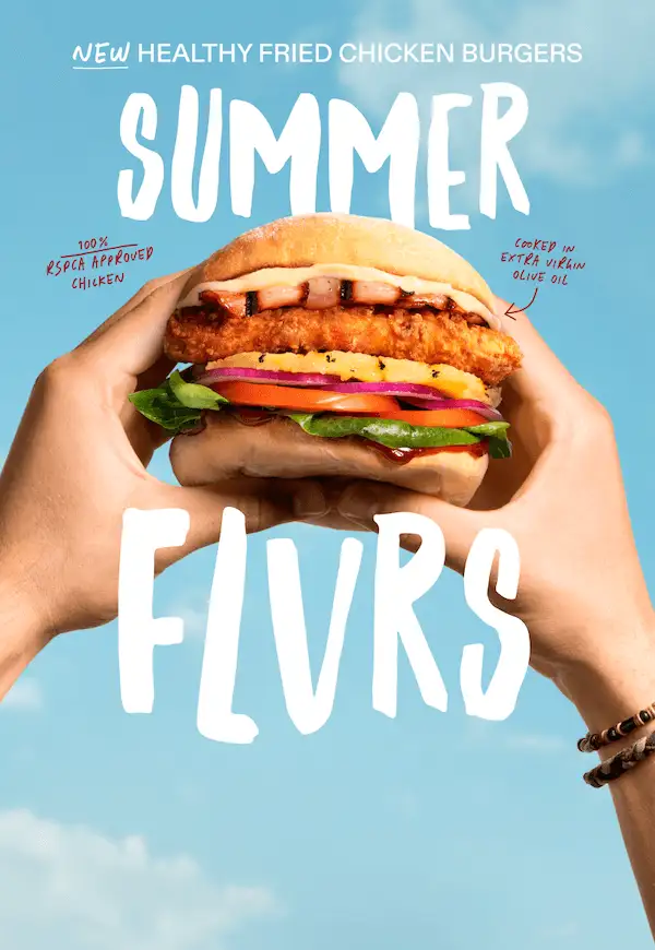 Two hands hold a healthy fried chicken burger against a bright blue sky. The burger features fried chicken, fresh lettuce, tomato, onion, and sauce in a toasted bun. Large white text reads ‘Summer Flvrs’, with small notes highlighting ‘100% RSPCA Approved Chicken’ and ‘Crisp in extra virgin olive oil’.