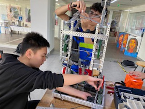 Image of two team members building robot.