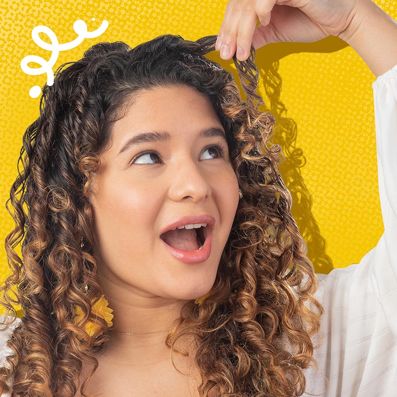 Woman displaying her moisturized curly hair