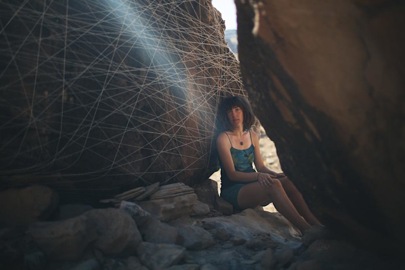 Charlotte X.C. Sullivan next to "Ford the River; Part Two" installation, Cabin-Time: Green River
