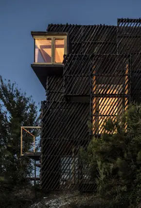 An Intricate Lattice of Waste Wood Protects this Cabin in Spain