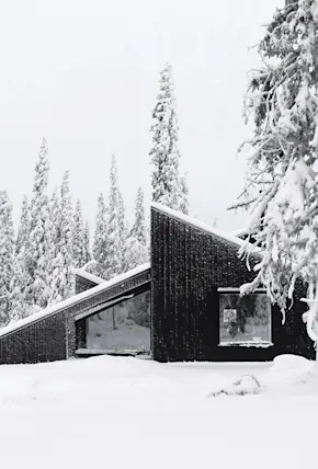 A Sculptural Cabin in Remote Norway Doubles as a Sledding Hill