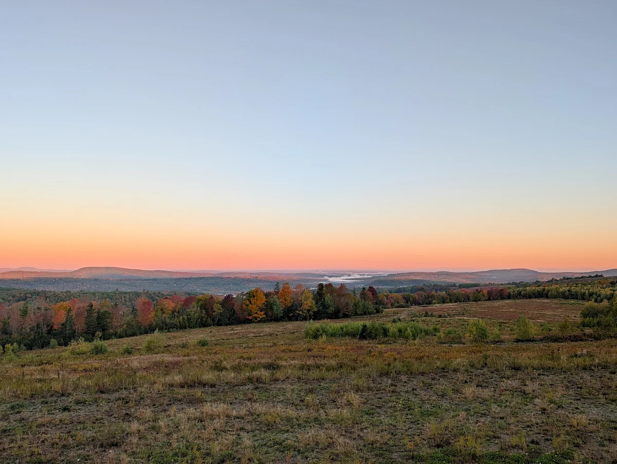 lantern-camp-hotel-review-maine-field-sunrise