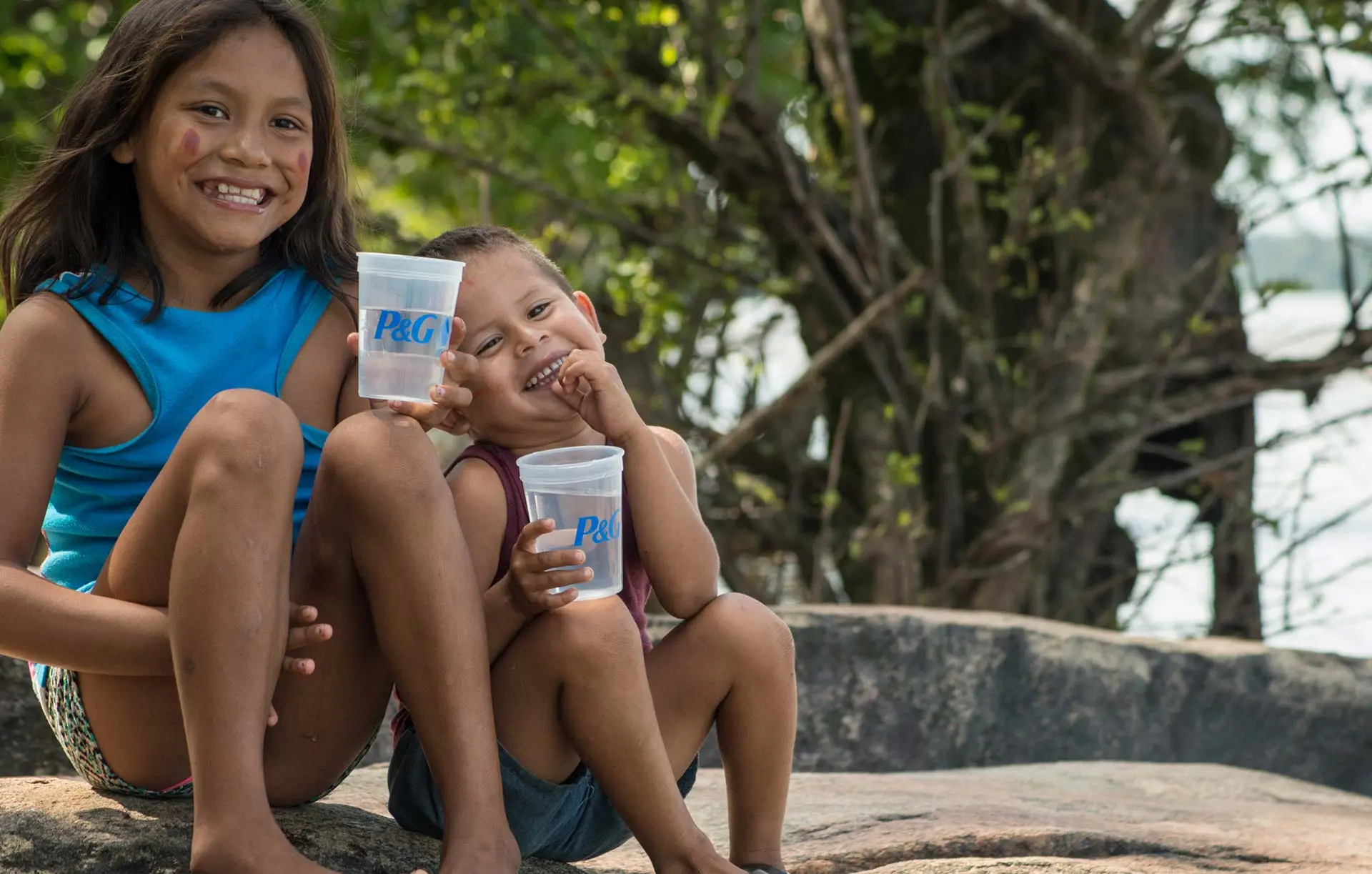 Children smiling with the glass of water