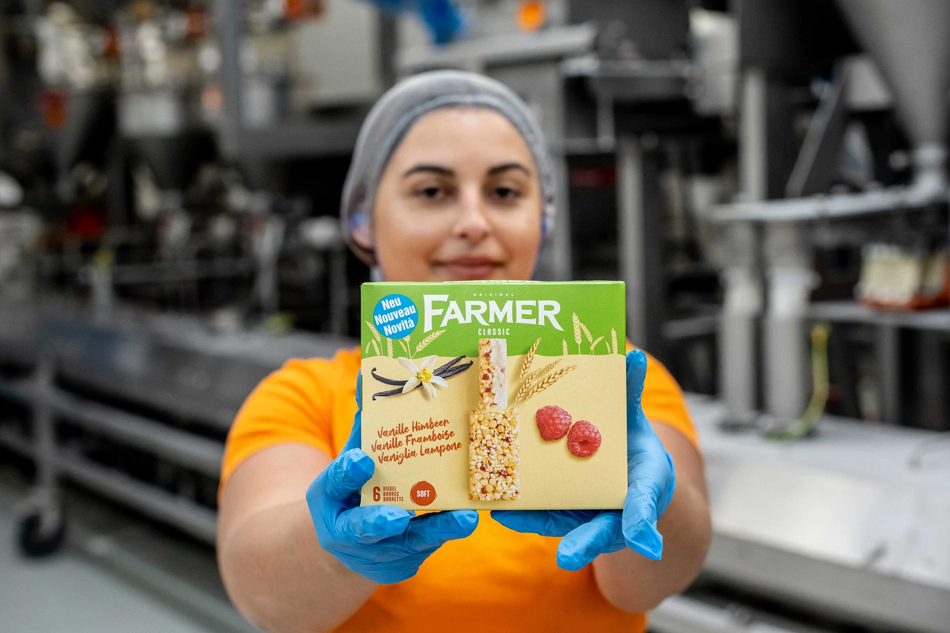 How farmer bars are made A Delica employee holds Farmer stalks of the new Vanilla Raspberry Sort in front of the camera.