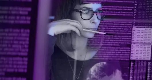 young woman studying a see through computer screen