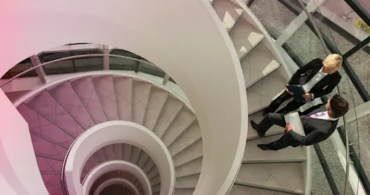 Business people talking on circular staircase