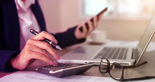 Close up of female accountant or banker making calculations