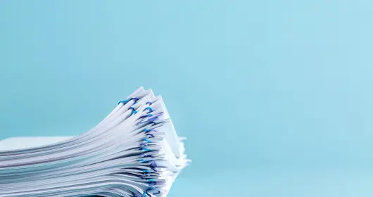 Stack of files on blue background