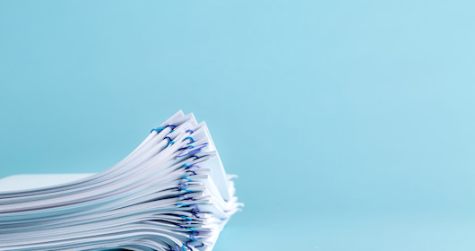 Stack of files on blue background