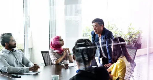 Business meeting in modern office view through glass