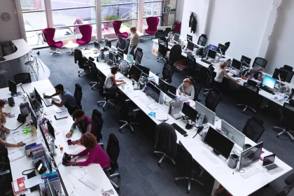 People working in large open space office 