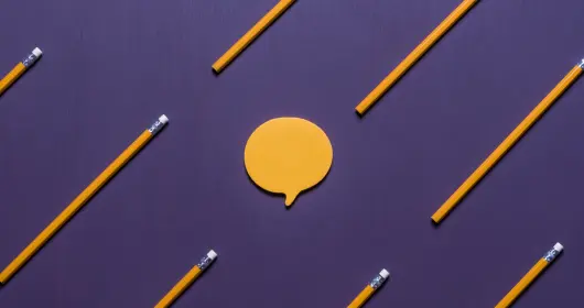 Pencils floating around chat bubble.