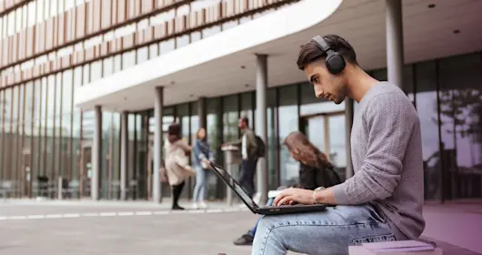Man with headphones on computer