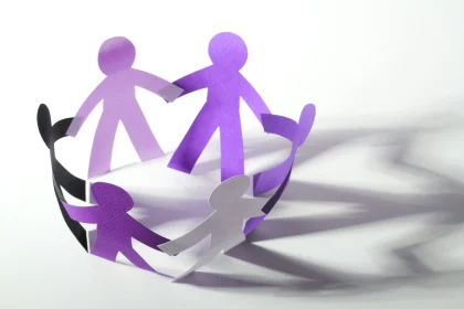 Paper cutouts of people holding hands in a circle