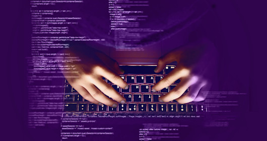 Illustration of hands typing on a keyboard appearing on top of computer code.