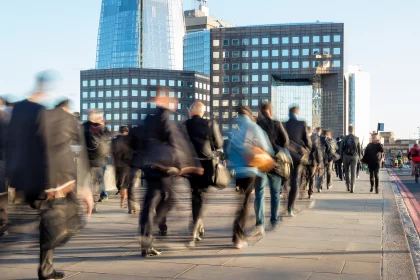 Blurred image of business commuters crossing London Bridge