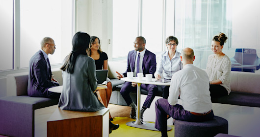 Group of businesspeople in discussion during project meeting in office