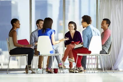 Creative business people meeting in circle of chairs