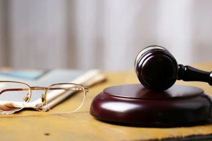 Eyeglasses and a gavel sitting on a table