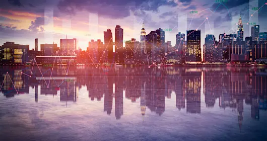 View of city with reflection on water in foreground