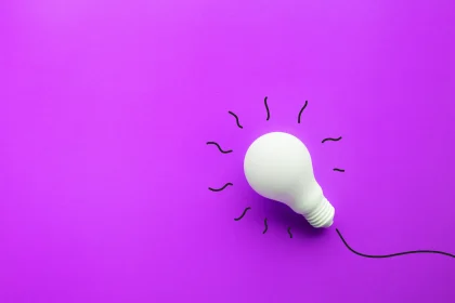 White light bulb on pastel colored background