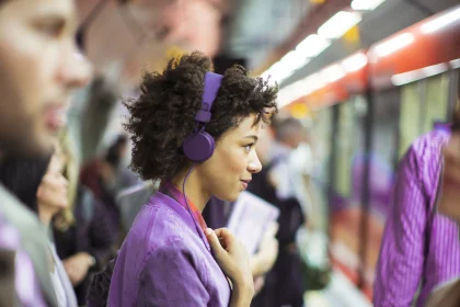 Woman listening to headphones in the train station