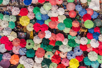 View from above many open umbrellas of different colors
