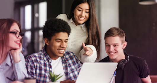 People gathering around computer