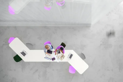 Overhead view of two people working in a modern office