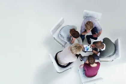 Group of people sitting on white chairs abstract
