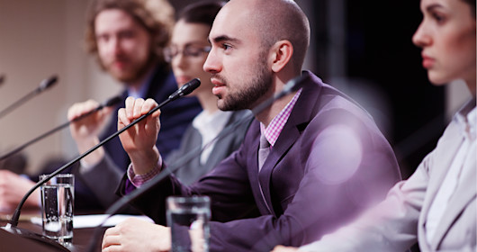 panel speakers sitting in front of microphones