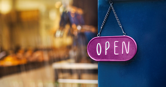 open sign hanging on a door