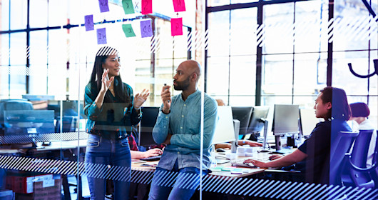 Colleagues talking in office