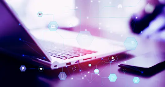 Laptop on desk with abstract vector overlay