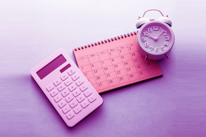 calculator, clock and calendar on desk