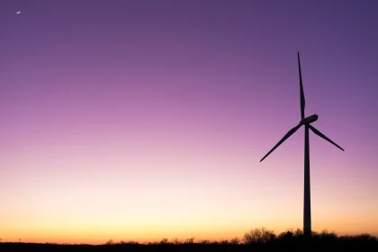 Wind turbine in a meadow at sunset