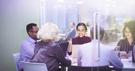 business people at laptops in conference room meeting