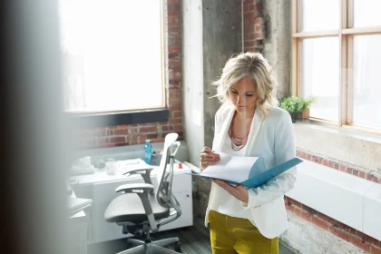 Businesswoman reviewing paperwork in office