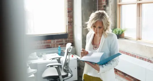 Businesswoman reviewing paperwork in office